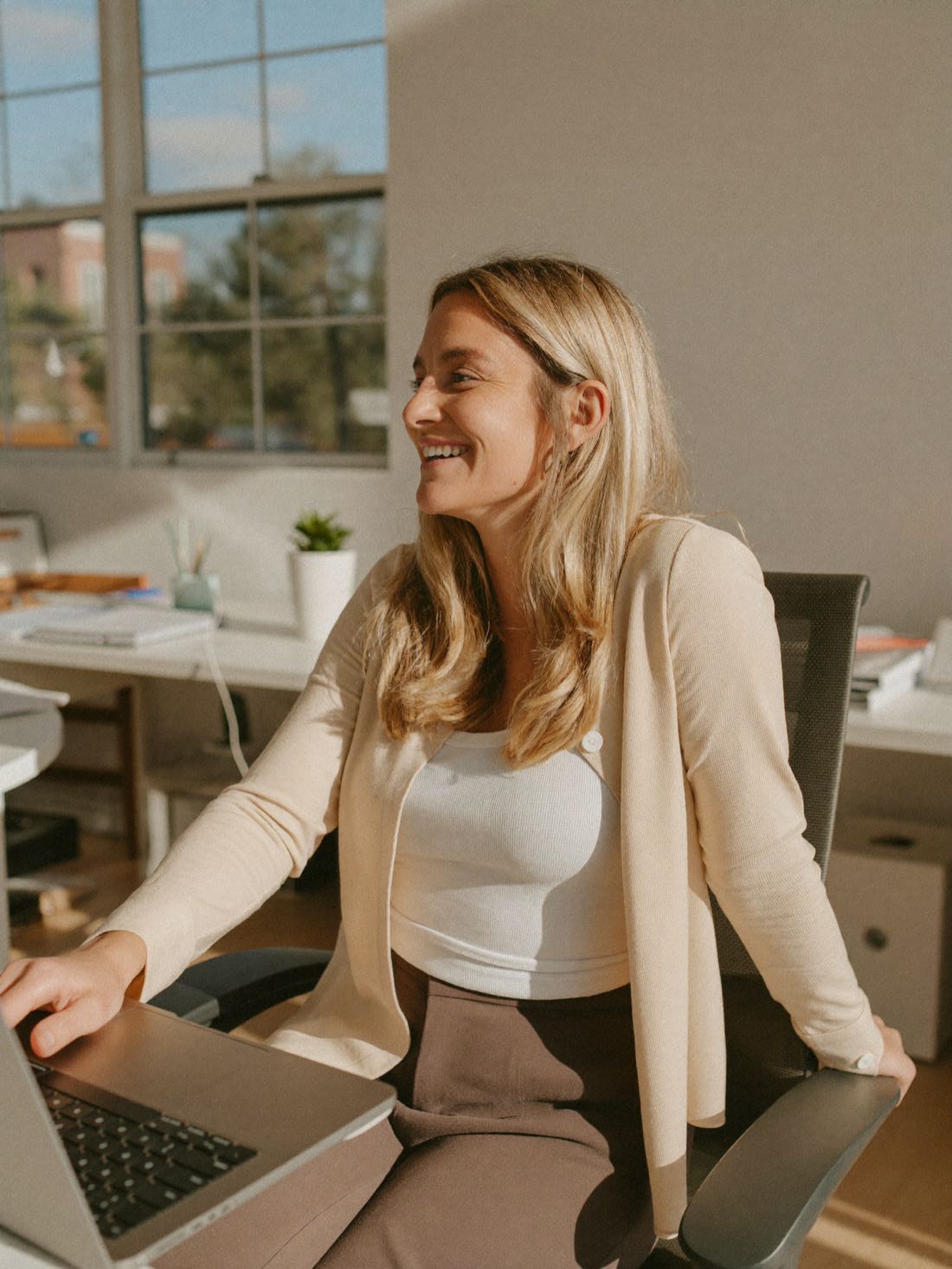 A payroll administrator at a laptop