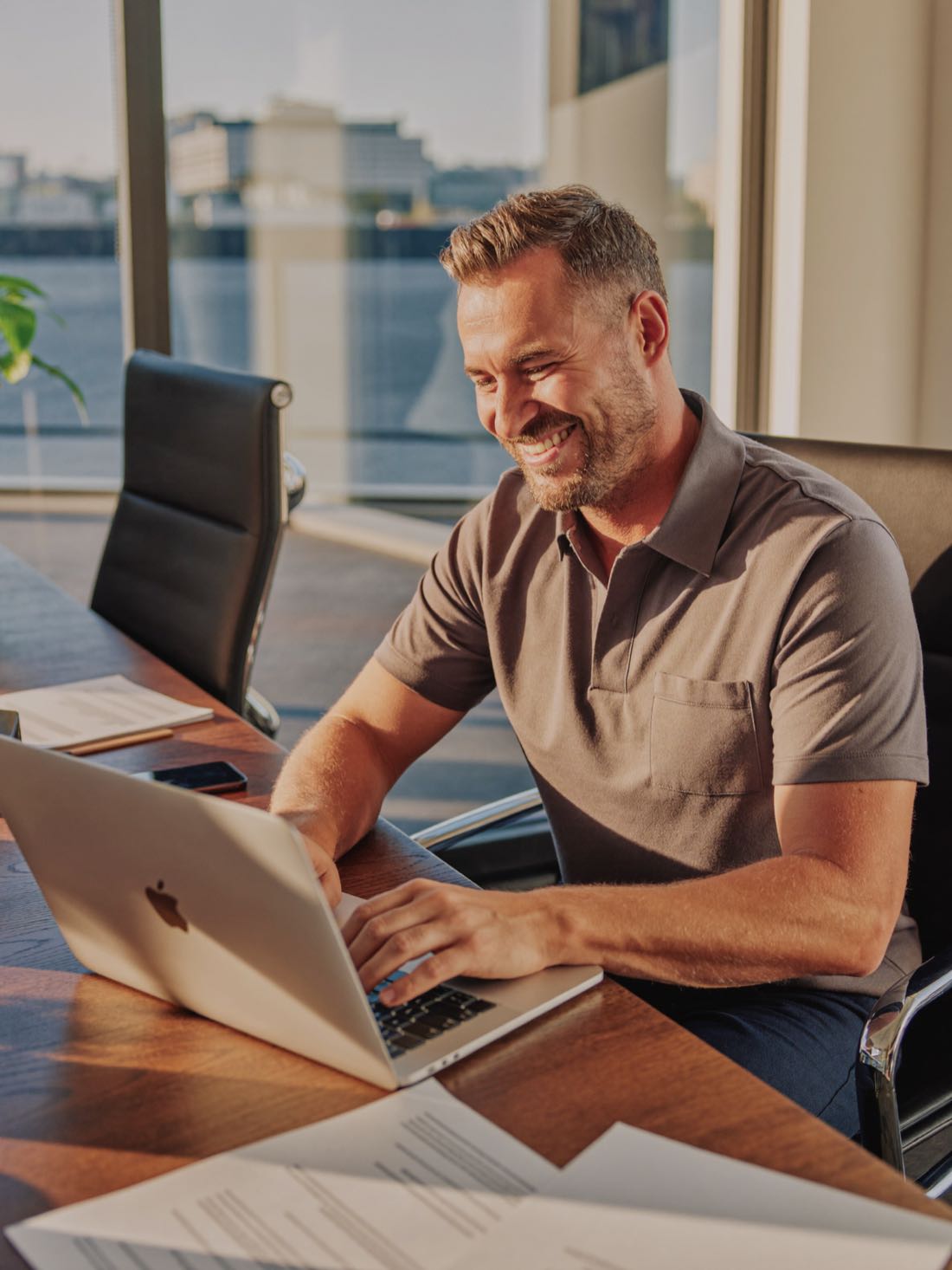 A loan officer smiling at his laptop